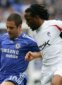 Joe Cole and Ricardo Gardner challenge for the ball